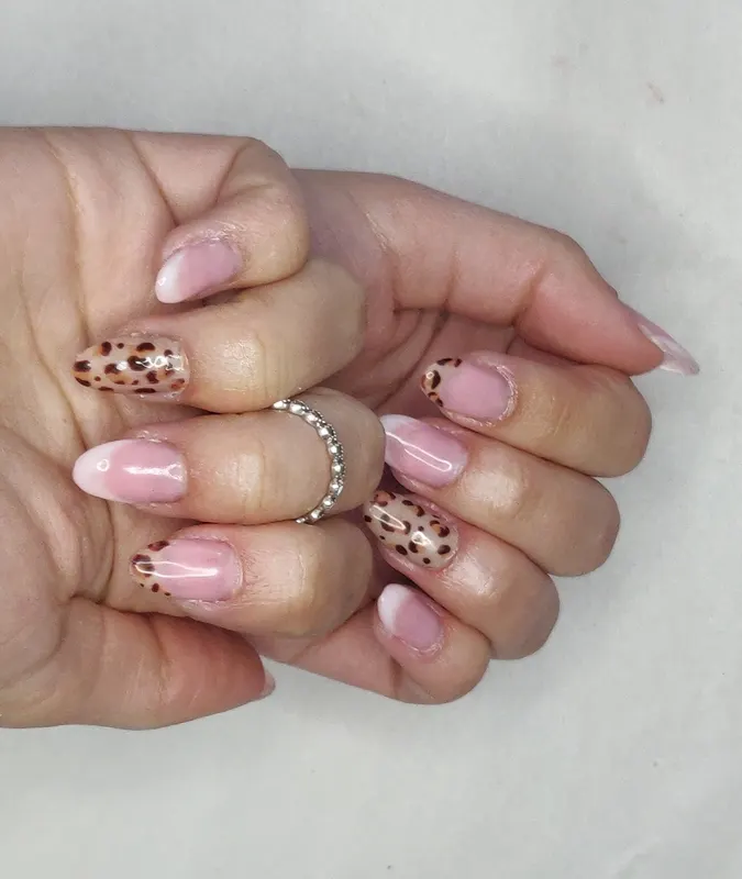 French tip with leopard print nail Oval. Extensions.